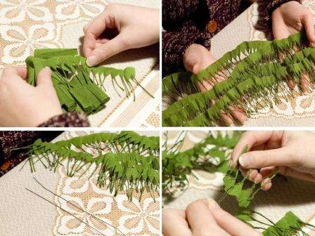 Neem een ​​stuk groen draad, buig het doormidden en haak eerst de linten met naalden. Begin met het draaien van de naalden op de tape, lichtjes verschuivend langs de lengte van de draad, zodat je een echt naaldtakje krijgt.